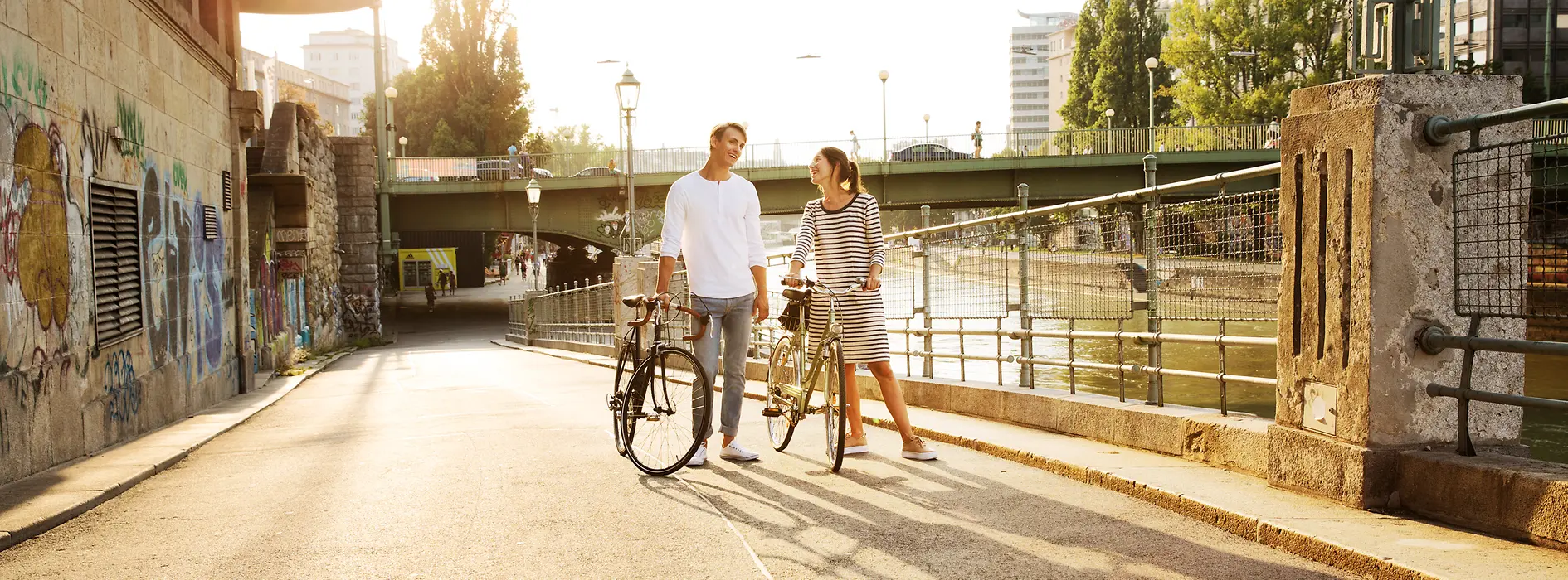 Two cyclists by the Danube Canal